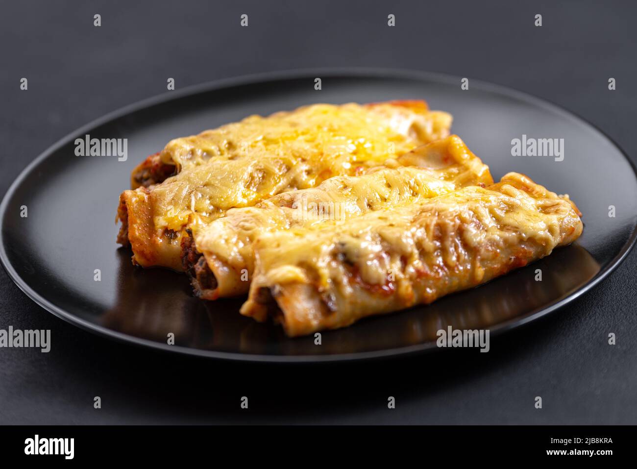 A portion of cannelloni. The traditional Italian dish of pasta tubes stuffed with meat Stock Photo