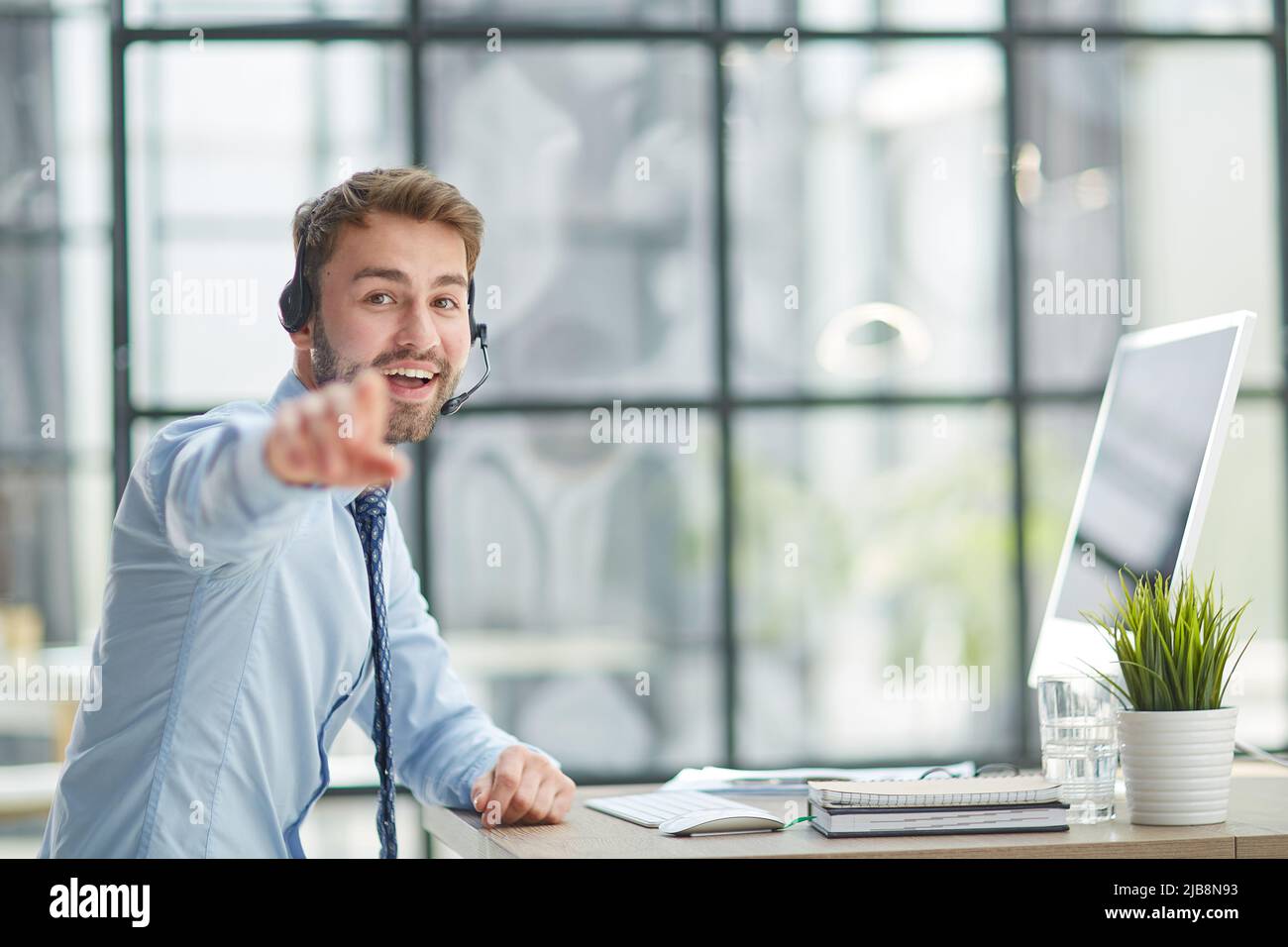 Man with headphones and laptop working in office Stock Photo