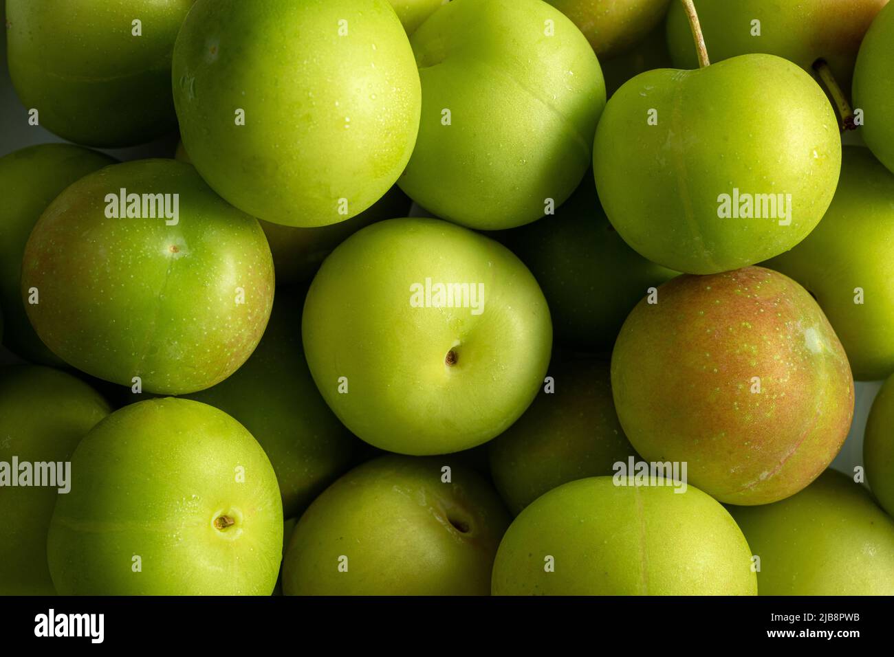 Full screen Stacked Fresh Green Plum (Japanese apricot) background