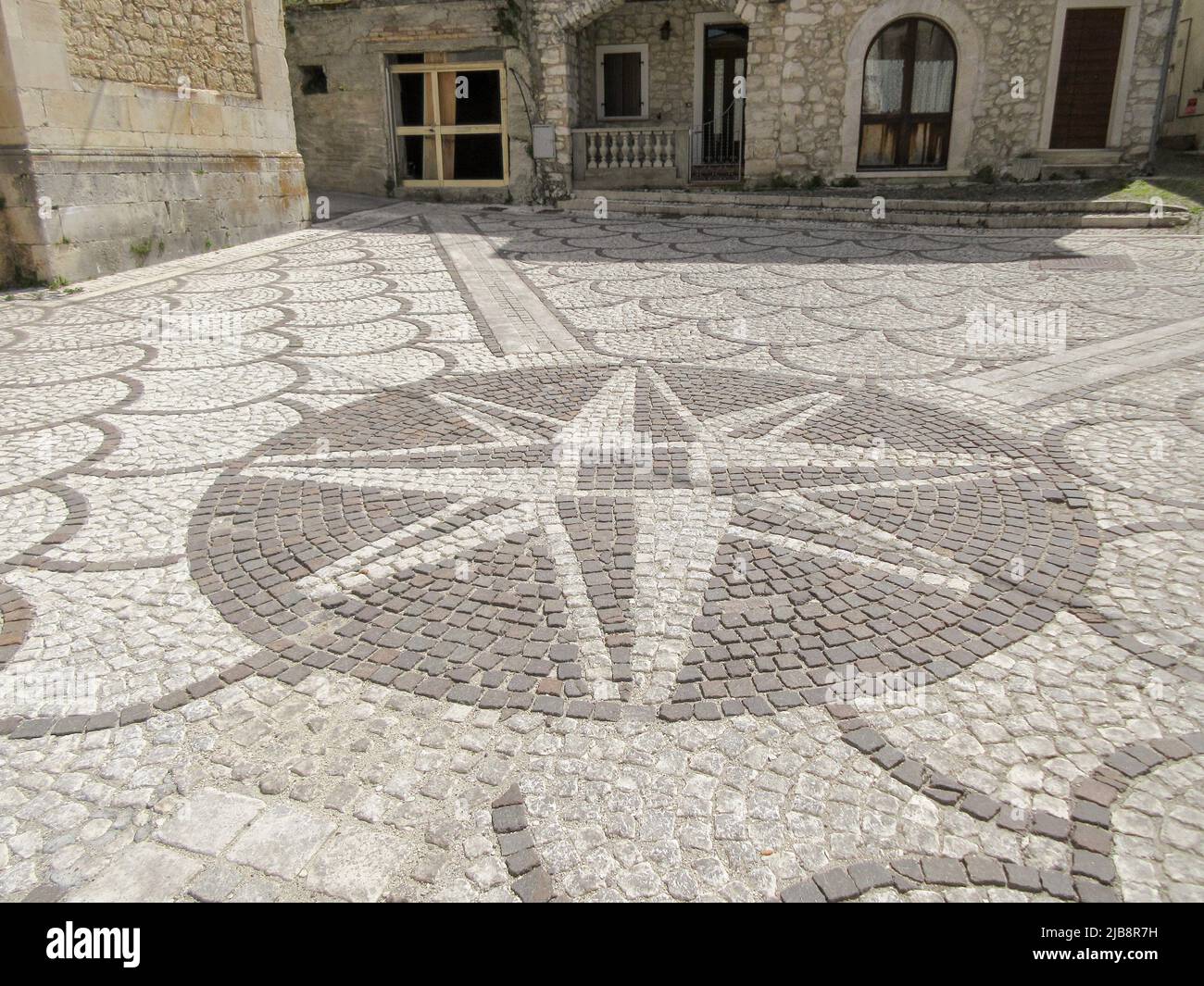 Floor of cobblestones with drawn the wind rose. Travel to Abruzzo Italy Stock Photo