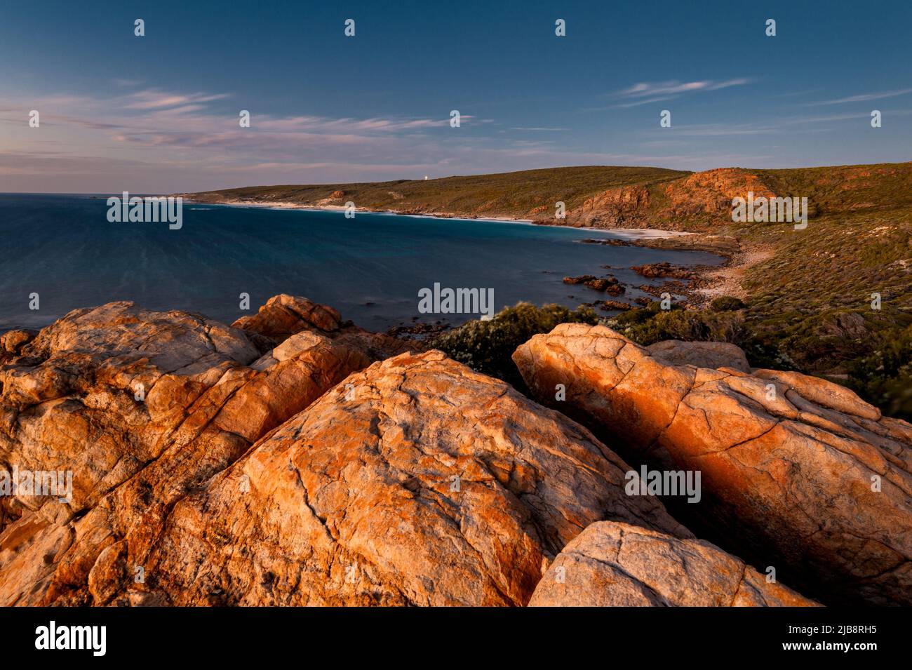 Late light on the rocks at the coast in Leeuwin-Naturaliste National Park, with a view on Cape Naturaliste. Stock Photo