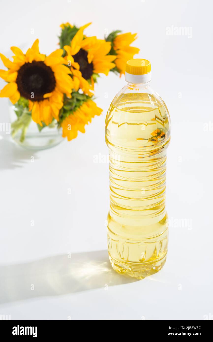 Bottle of sunflower oil with flower isolated on white background Stock Photo