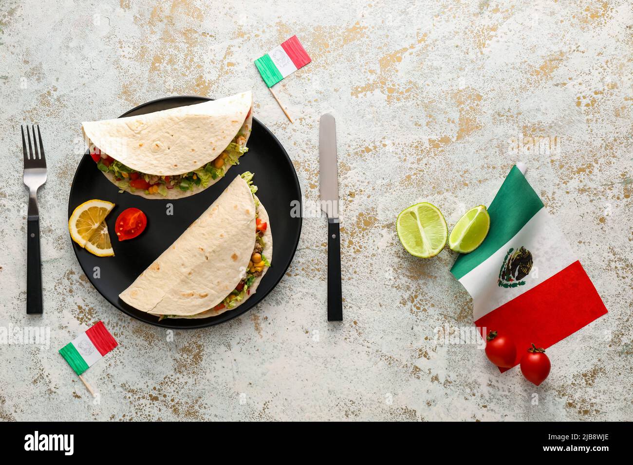 Composition with Mexican traditional tacos and flags on light