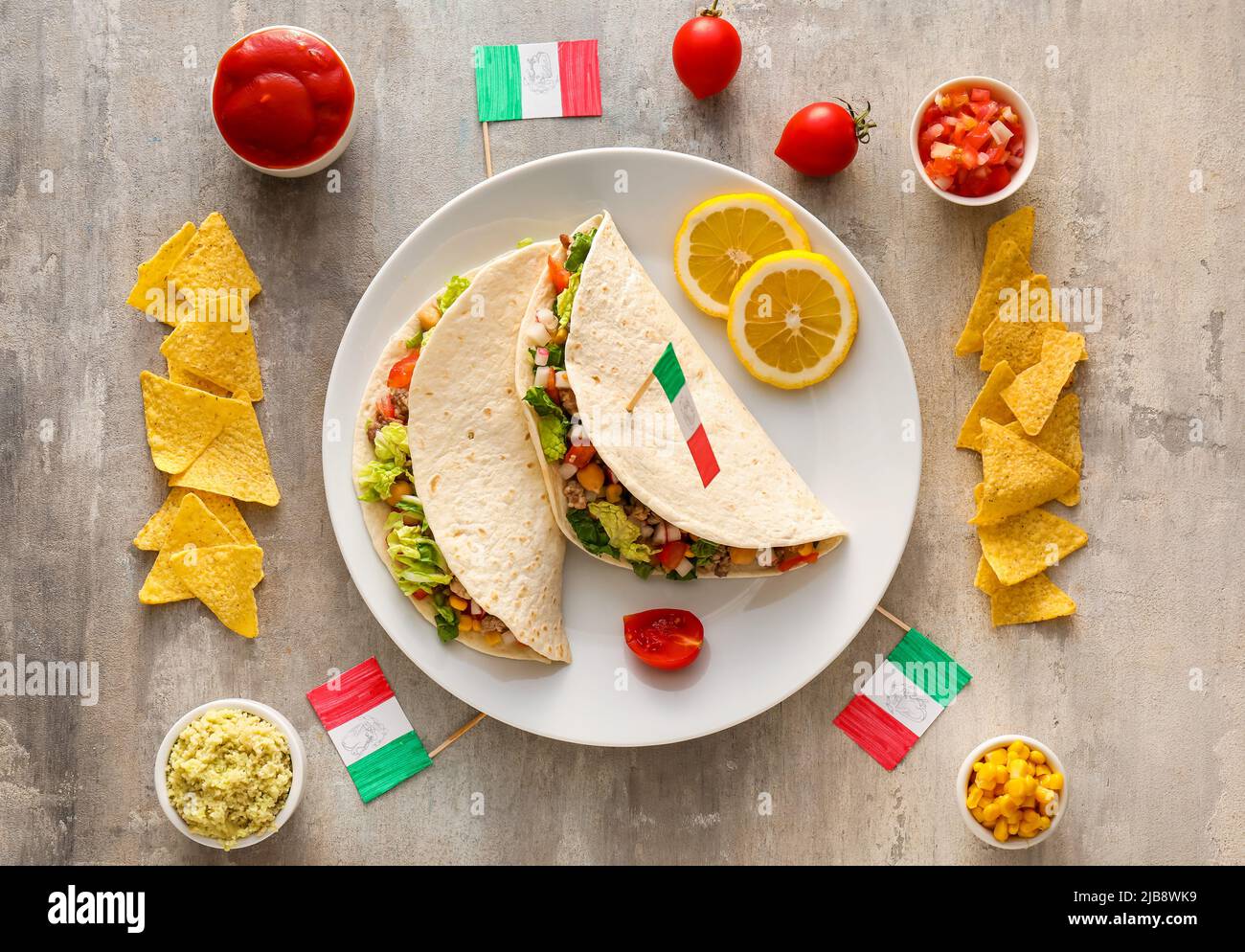 Composition with Mexican traditional tacos and flags on light