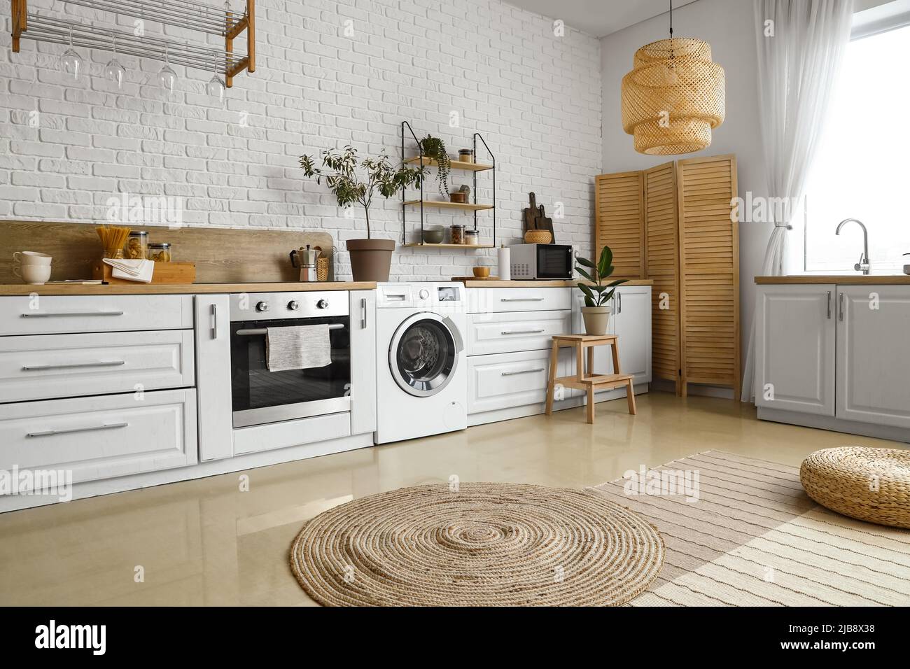 Stylish interior of kitchen with modern washing machine Stock Photo - Alamy