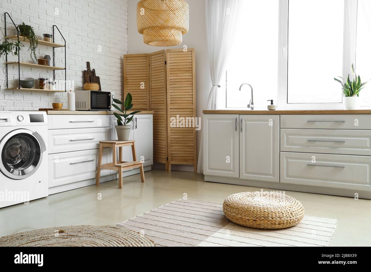Stylish interior of kitchen with modern washing machine Stock Photo - Alamy