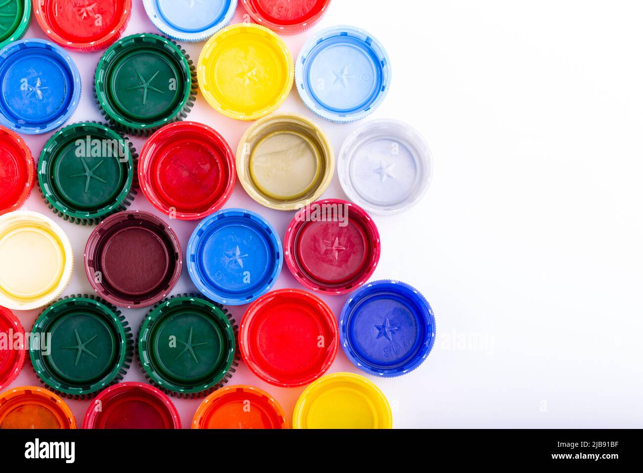 Plastic bottle caps on white background. Cap material is