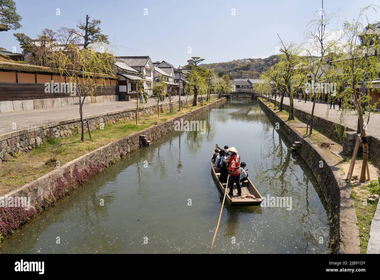 Tourists on a boat ride on the Kurashiki River, Kurashiki Bikan Historical Area, Kurashiki, Okayama Prefecture, Western Honshu, Japan. Stock Photo