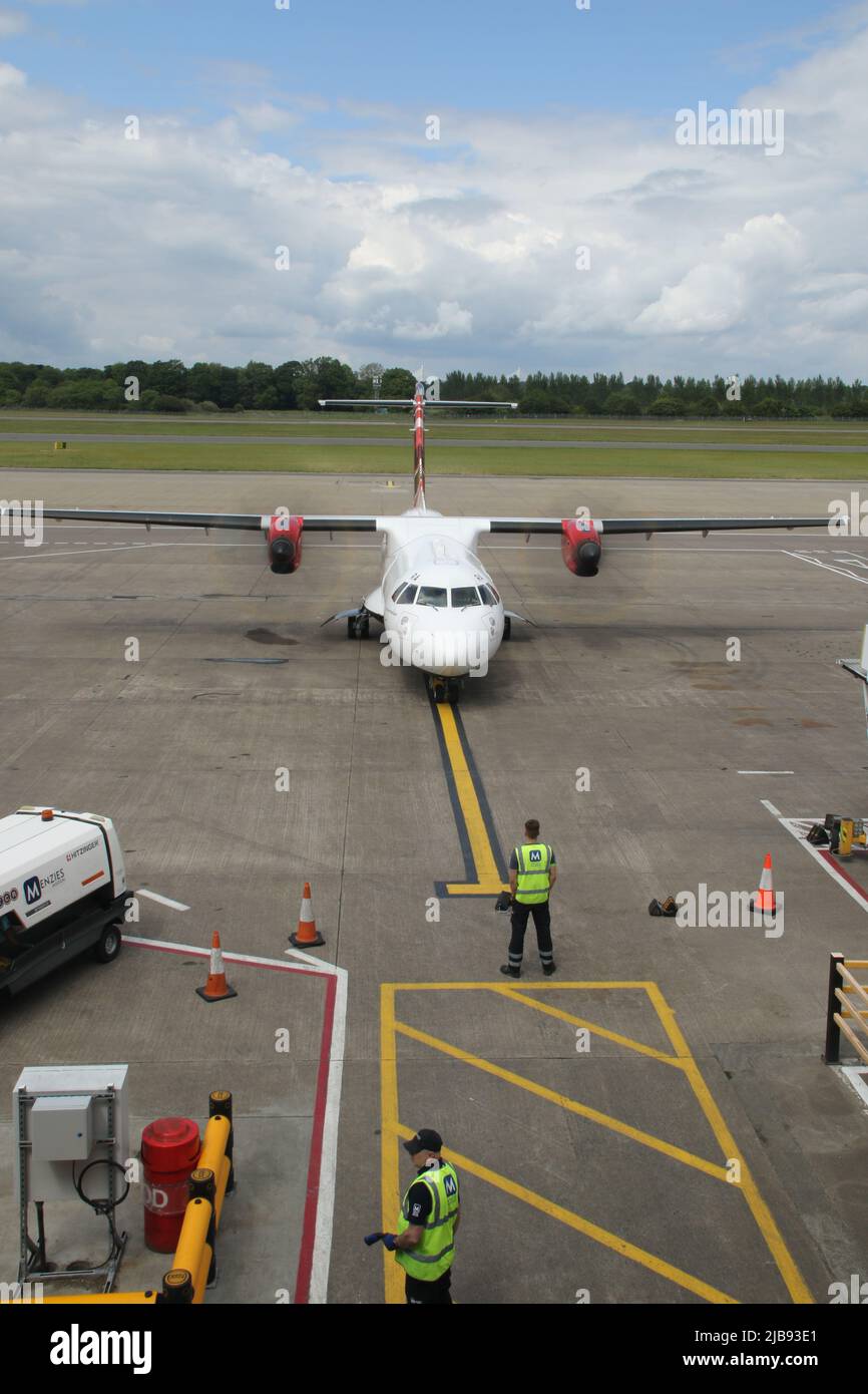 plane being guided into stand at Edinburgh airport Stock Photo