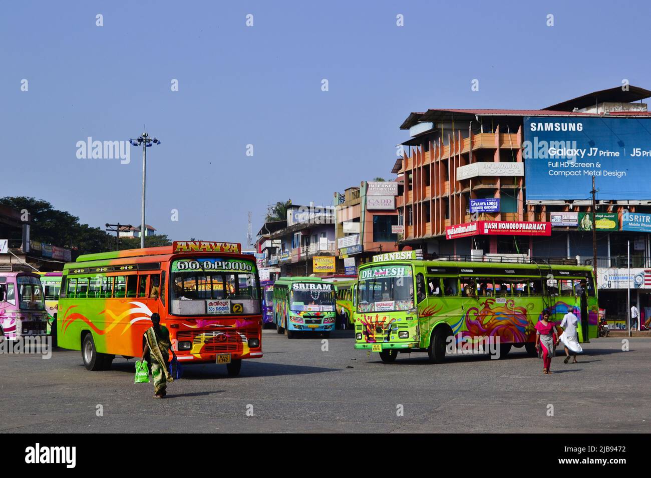 Thalassery, Kerala, India - January, 2017: Bright multi-colored passenger buses at bus station. Colorful Indian buses with abstract custom patterns Stock Photo