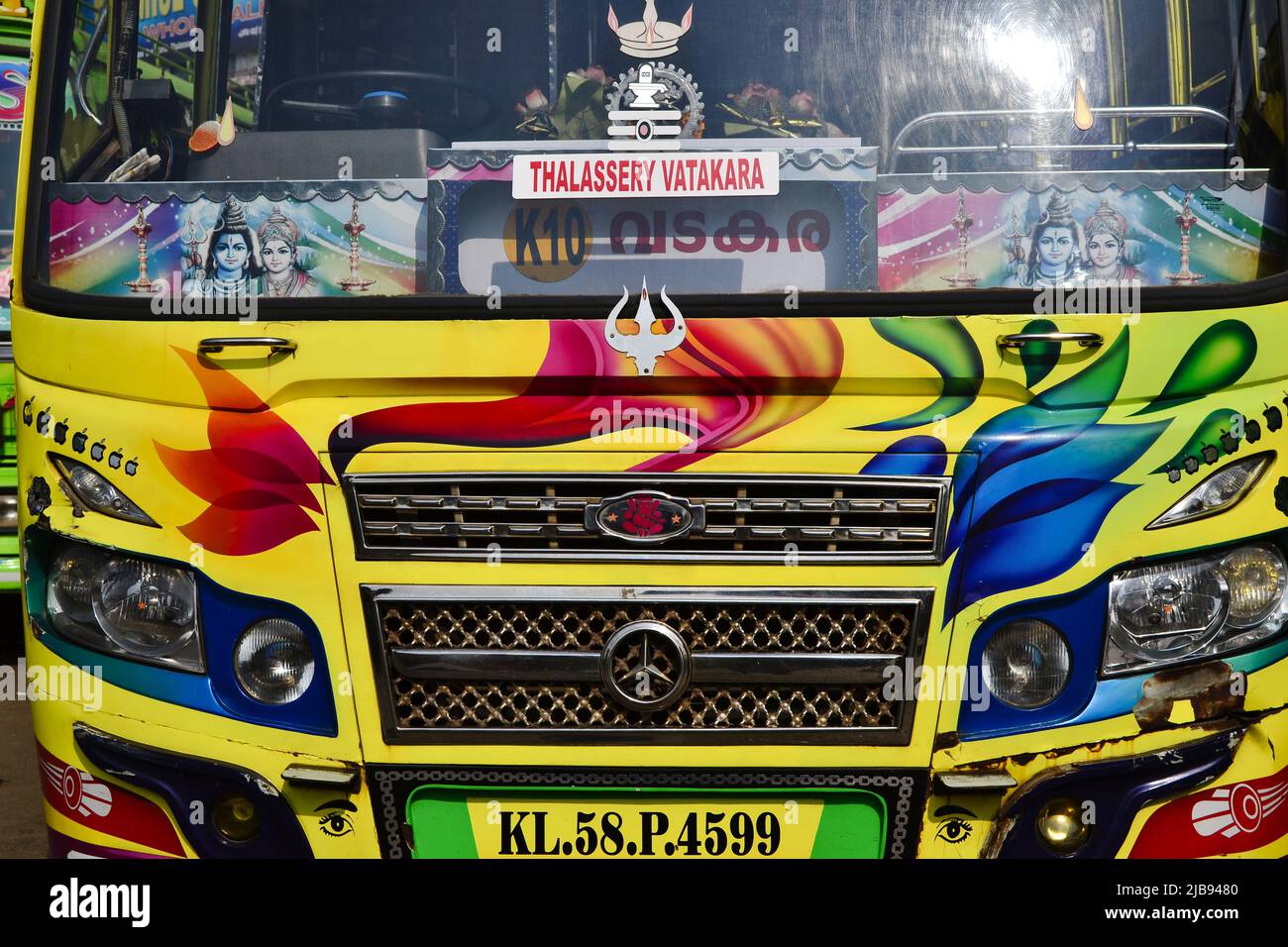 Thalassery, India - January, 2017: Front view of colorful Indian Mercedes bus making route from Thalassery to Vatakara. Headlights and Radiator grill Stock Photo
