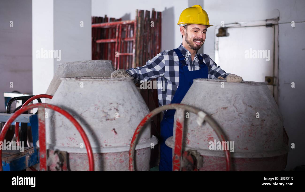 Worker work with cement mixer Stock Photo Alamy