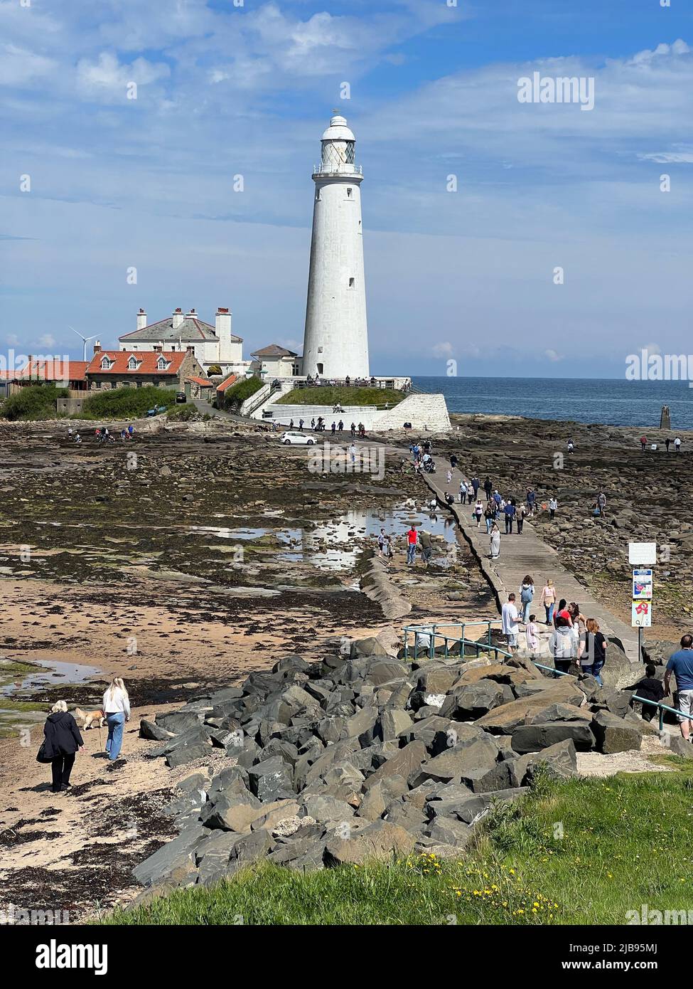 Blyth, UK. 03rd June, 2022. People celebrating the Jubilee weekend by walking to St Mary's Lighthouse (Blyth) at low water Credit: Miroslav Valasek/Alamy Live News Stock Photo