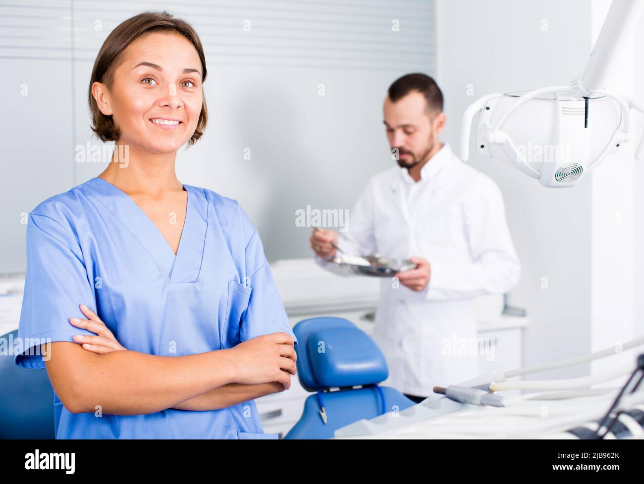 doctor with assistant are posing on workplace in hospital Stock Photo