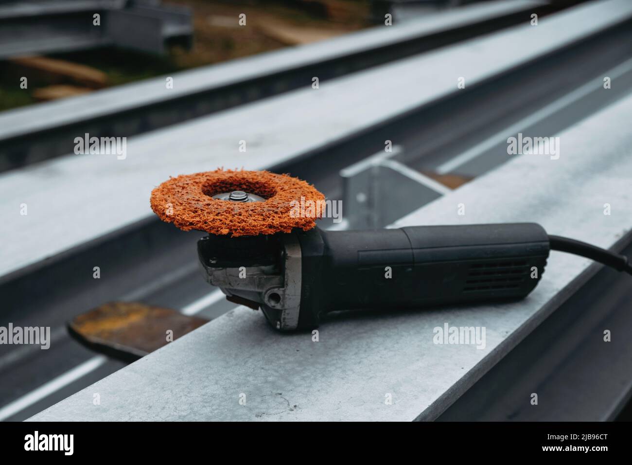 Sander for metal beams on construction site. Professional portable