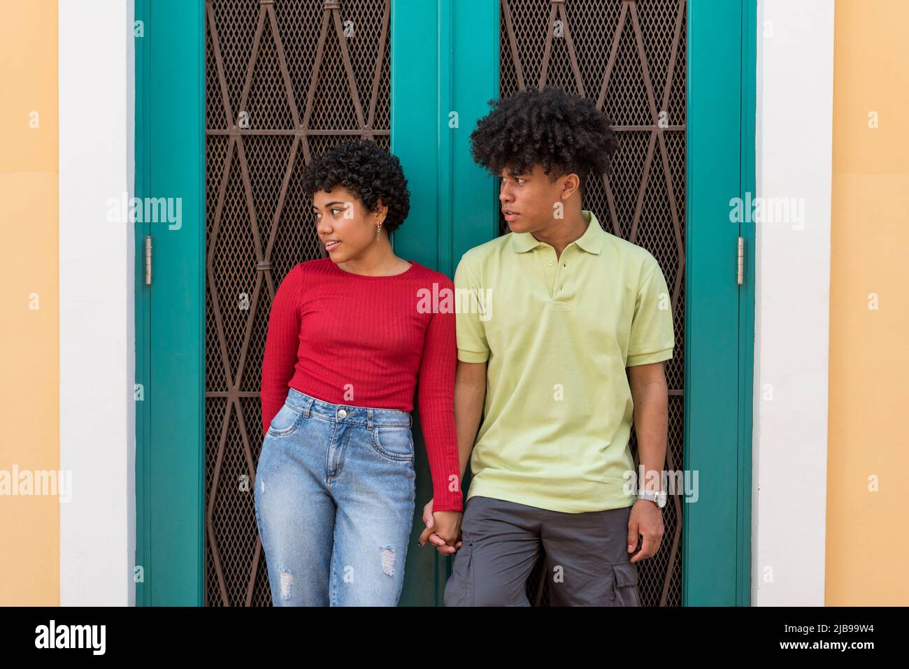Portrait of smiling couple in front of wall, Panama city - stock photo Stock Photo