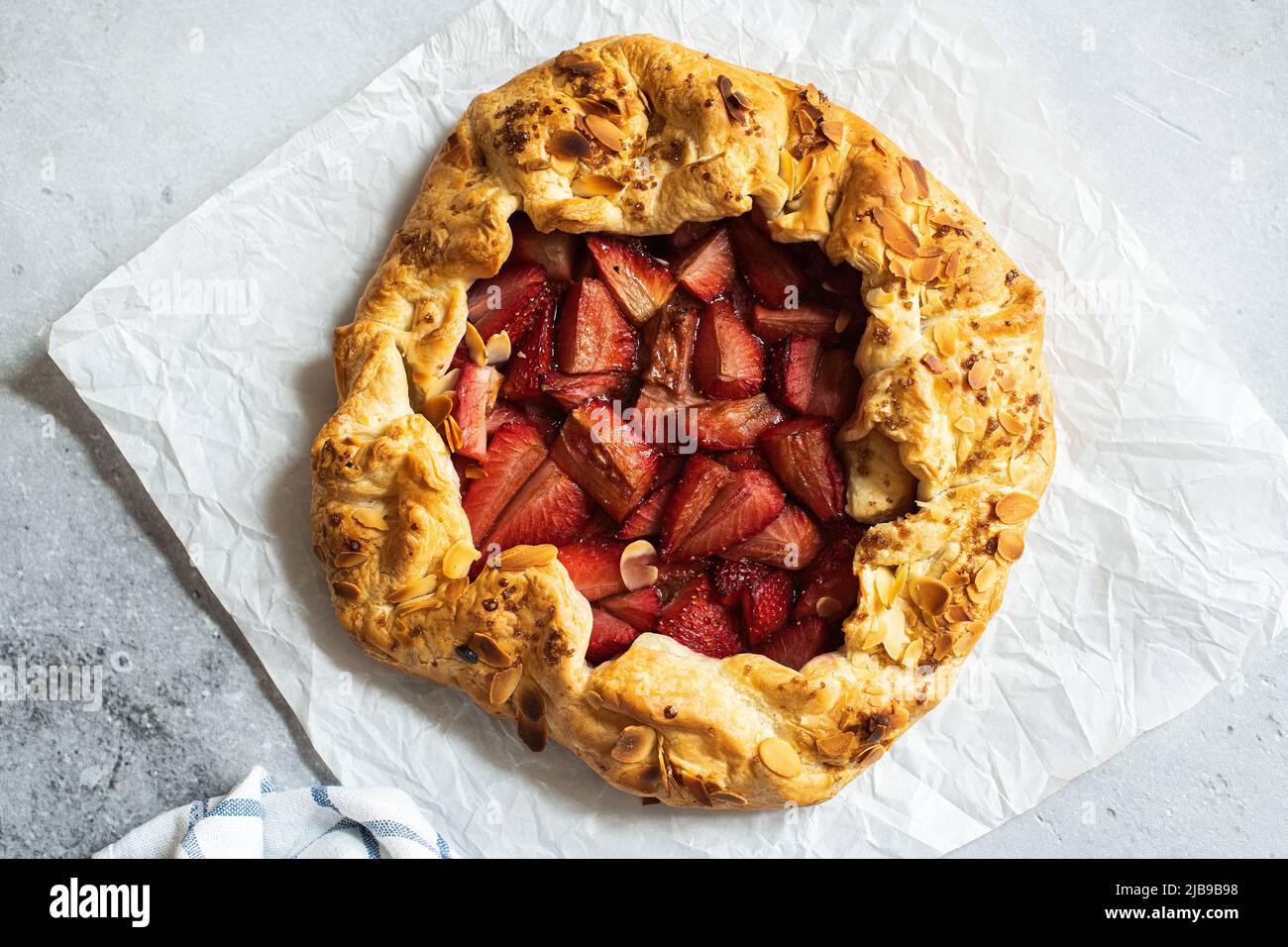 Strawberry summer galette with puf pastry and almond flakes. Stock Photo