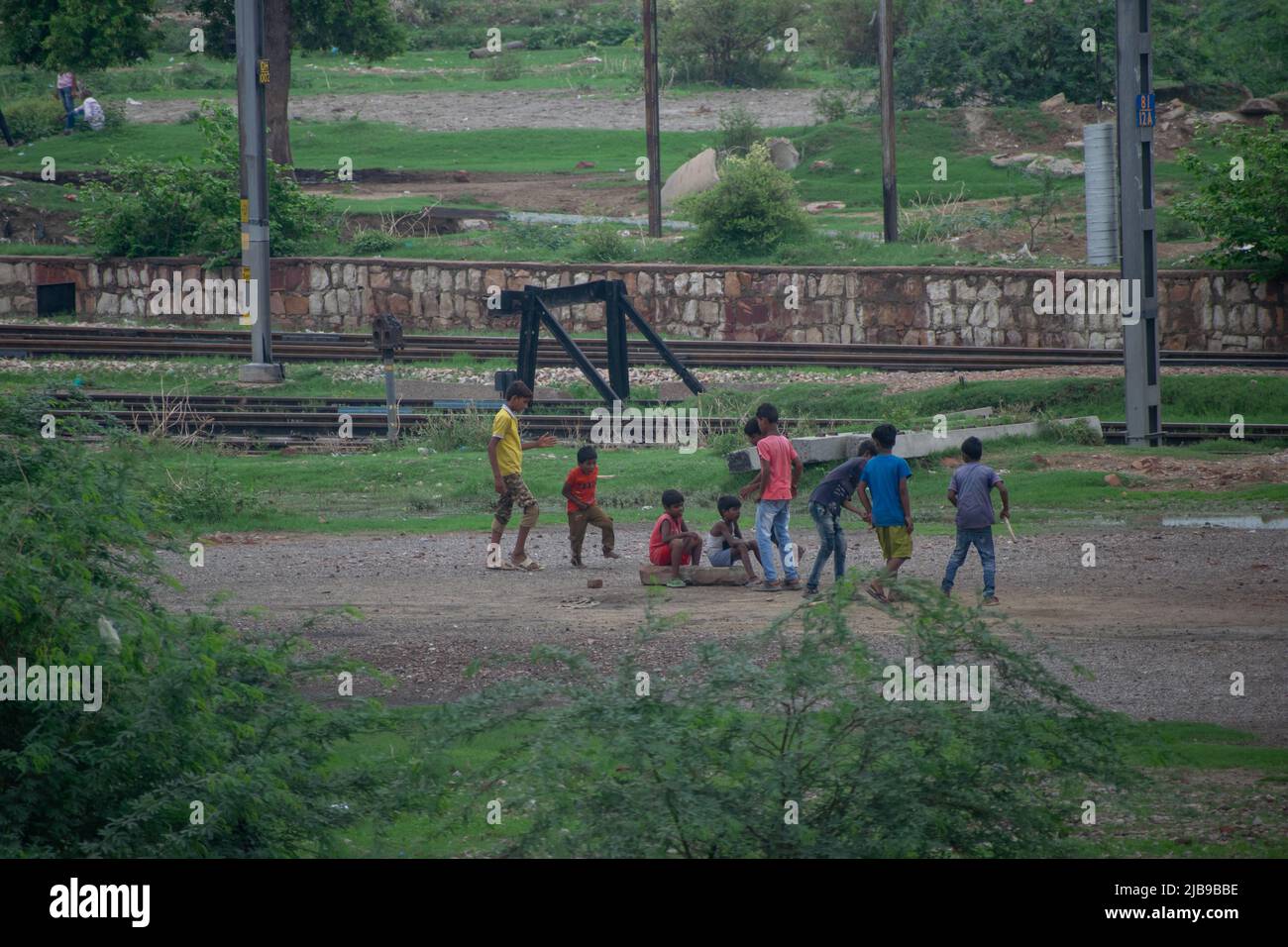 Kids playing in a ground near railway station Stock Photo