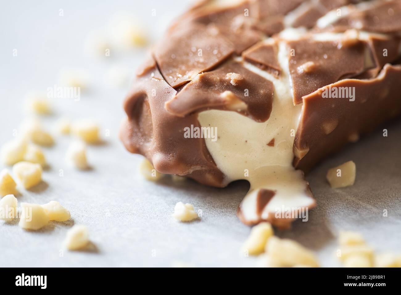 Bited almond vanilla ice-cream with chocolate glaze. Stock Photo