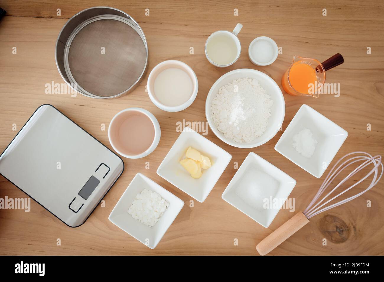 A set of ingredients and tools for baking an orange cake Stock Photo