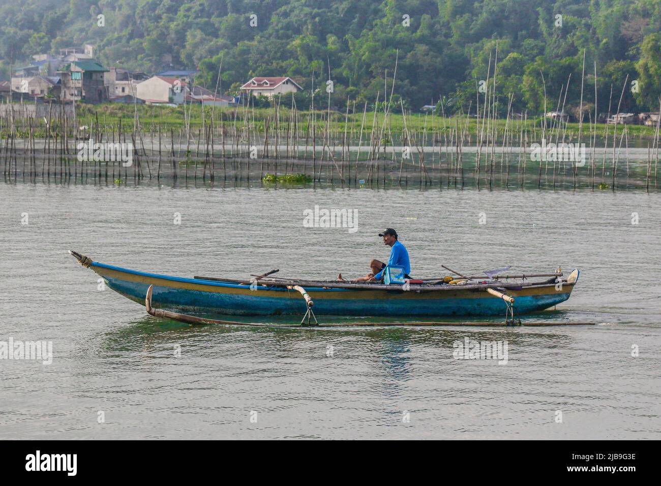 Binangonan, Philippines. 04th June, 2022. A fisherman rows his boat off to take a chance on catching a fish. Laguna Lake is the largest lake in the Philippines, covering a surface of 900 square kilometers or equivalent to 90,000 hectares. Its water runs from Laguna Province all the way to the Province of Rizal, the southern part of Luzon. The lake provides resources like transportation, recreation, livelihood, and most importantly food for the surrounding communities. Laguna Lake is classified as Class C freshwater which has the capability to grow fish and other aquatic resources. Some watersh Stock Photo