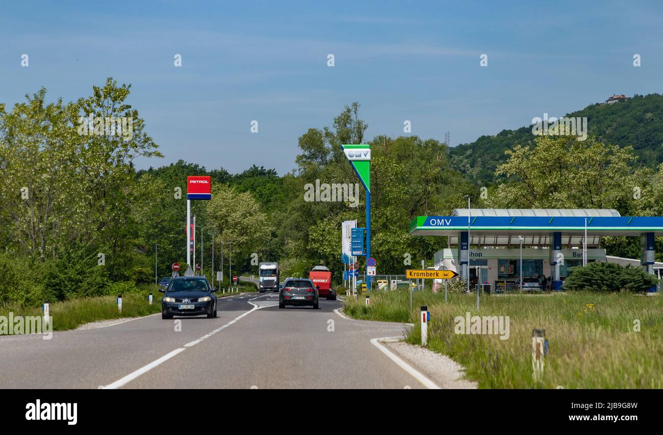 A picture of two Slovenian gas stations, Petrol and OMV, on a countryside road. Stock Photo