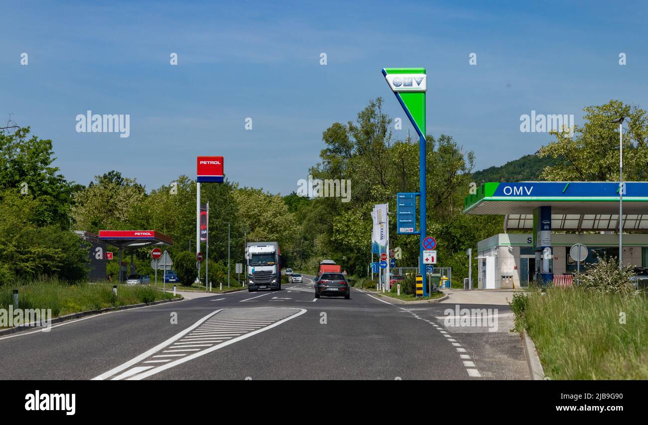 A picture of two Slovenian gas stations, Petrol and OMV, on a countryside road. Stock Photo