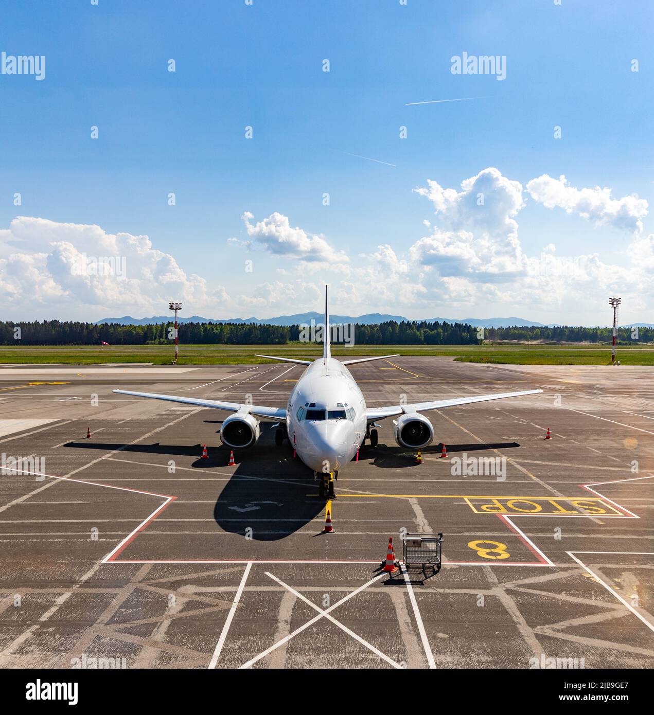 A picture of an airplane parked on the Ljubljana Airport. Stock Photo