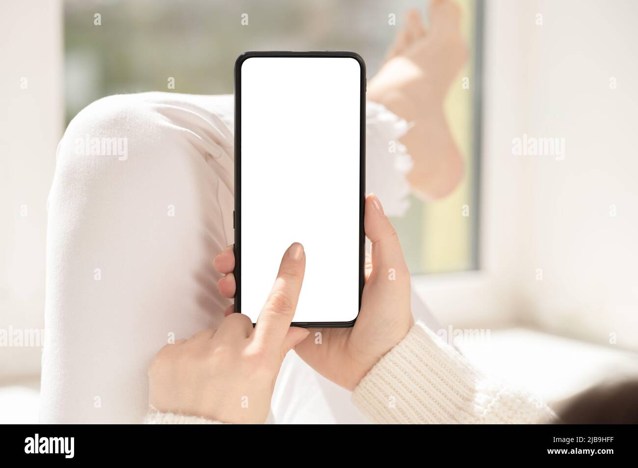Cellphone mockup. woman finger presses on cell phone screen. Use mobile shopping app, check social media news, texting mobile sms order food delivery Stock Photo