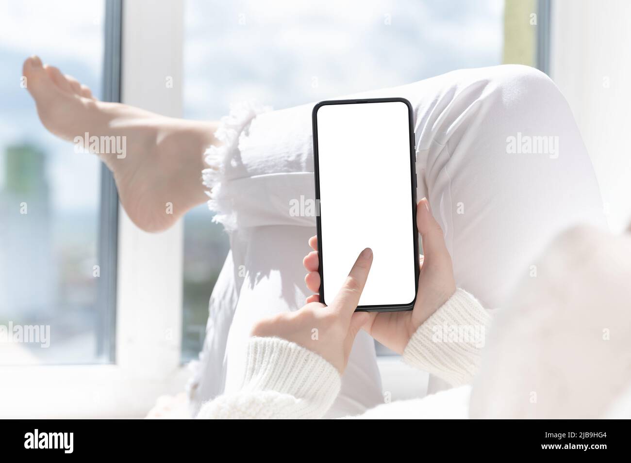 Cellphone mockup. woman finger presses on cell phone screen. Use mobile