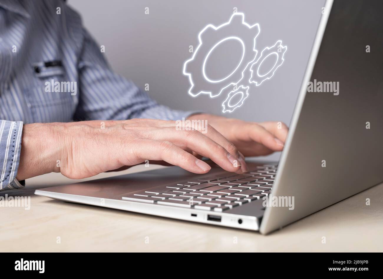 Man installing, configuring system settings at laptop. Computer repair, technical support concept. Sysadmin or IT administrator profession. High quality photo Stock Photo