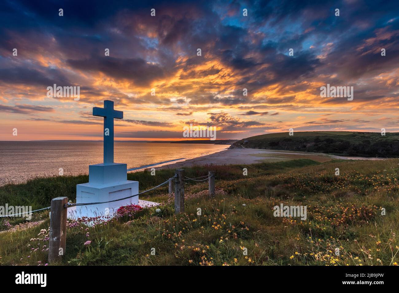 A landscape of the Anson Memorial overlooking Loe Bar in Cornwall at Sunset. In the distance Porthleven can just be glimpsed. Stock Photo