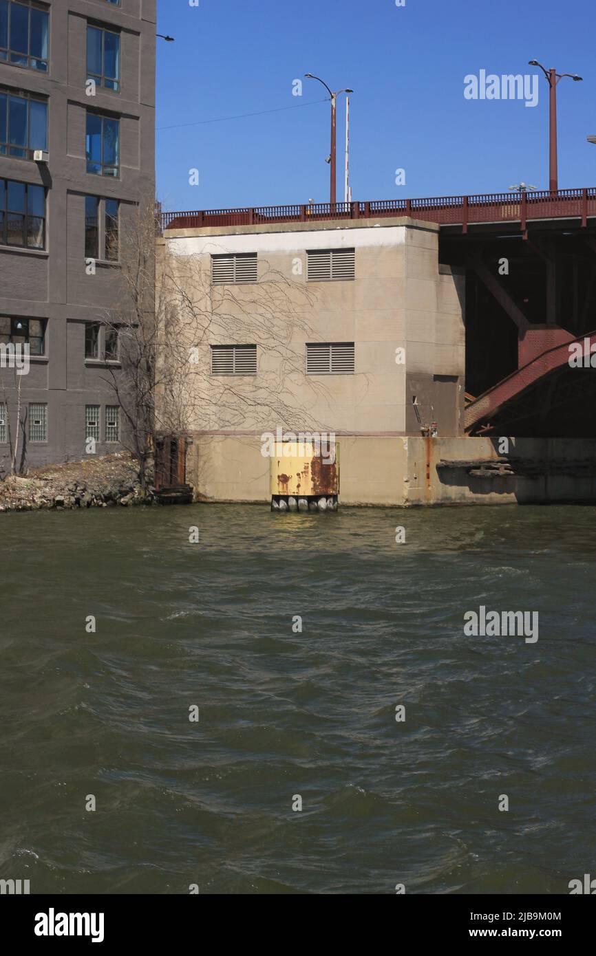 Image showcasing Industrial warehouse building set on the riverfront near a bollard ...