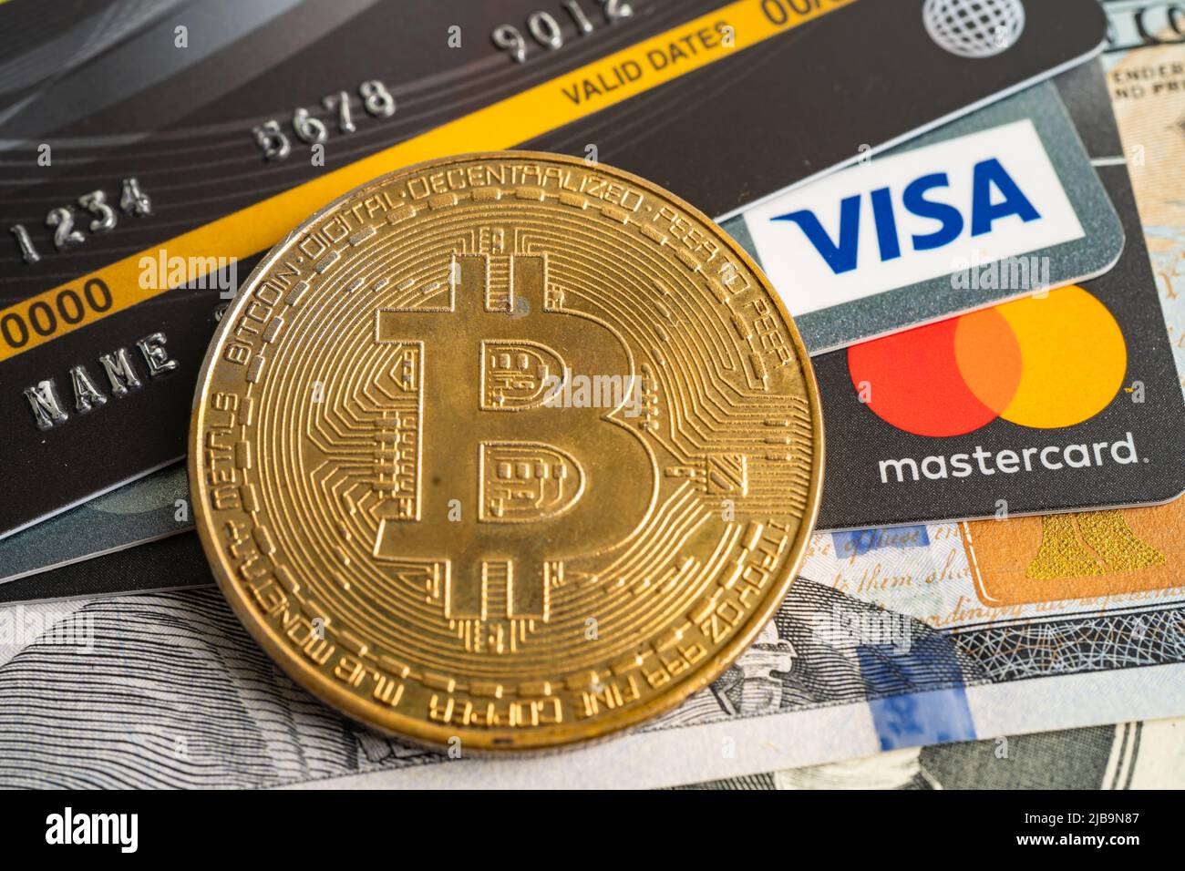 Bangkok, Thailand, July 9, 2021, Gold bitcoin with credit card on US dollar  banknotes for electronic worldwide exchange virtual money, blockchain, cry  Stock Photo - Alamy