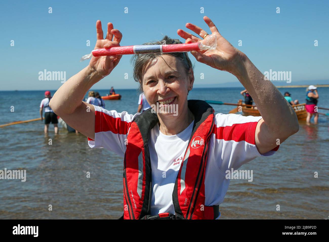 Troon, UK. 04th June, 2022. 04 June 2022. Troon, UK. Troon Coastal Rowing Club (TCRC) held its annual regatta on the Firth of Clyde sailing from south beach Troon, Ayrshire, UK. The small boats are traditional, hand crafted, wooden, 4 crew, fishing skiffs, based on a 300 year old design. The race requires the competitors to row a set course of not less than 2 kilometres, leaving from the shore and on return, a team member has to take a stick of Troon rock (confectionery} and run to the finish line with it. The event attracted competitors from various coastal rowing clubs across Scotland Stock Photo
