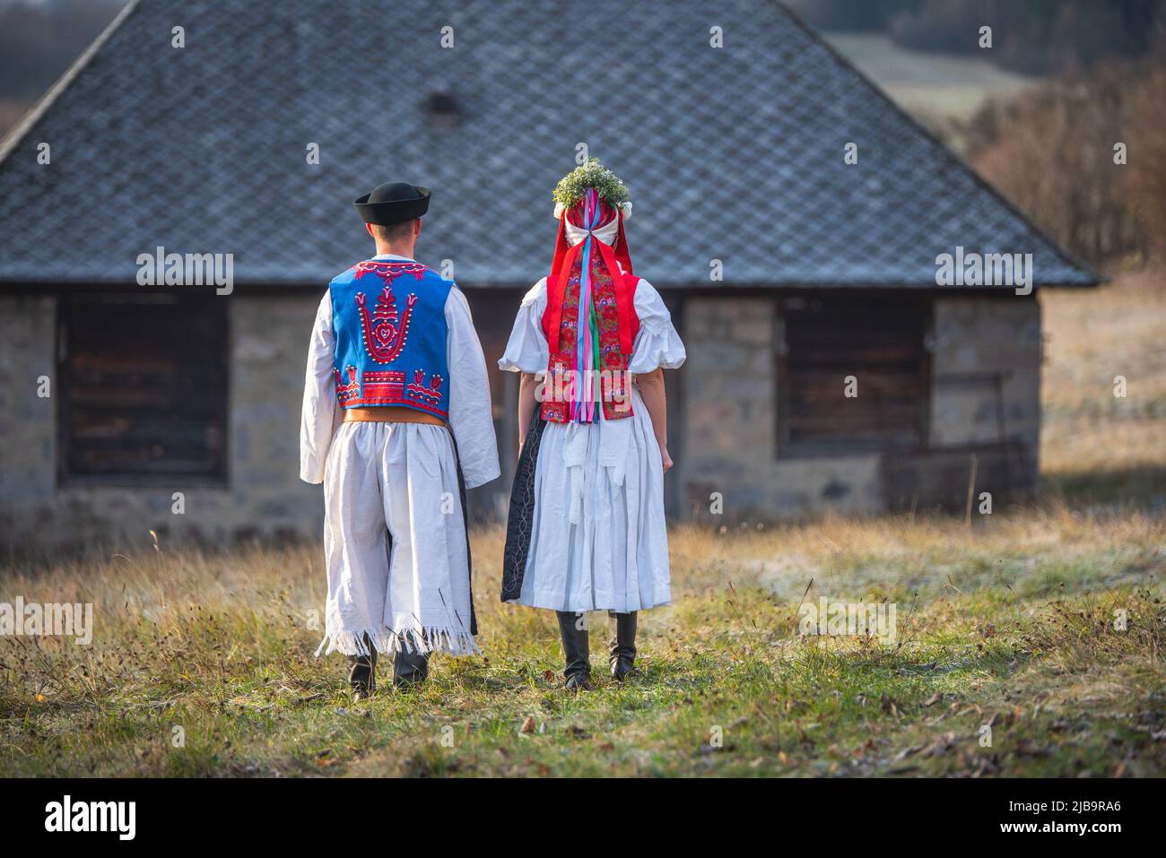 A couple dressed in traditional folk costume. Slovak costume in autumn  nature. Old country cottage in the background. Young couple in folk costume  wal Stock Photo - Alamy