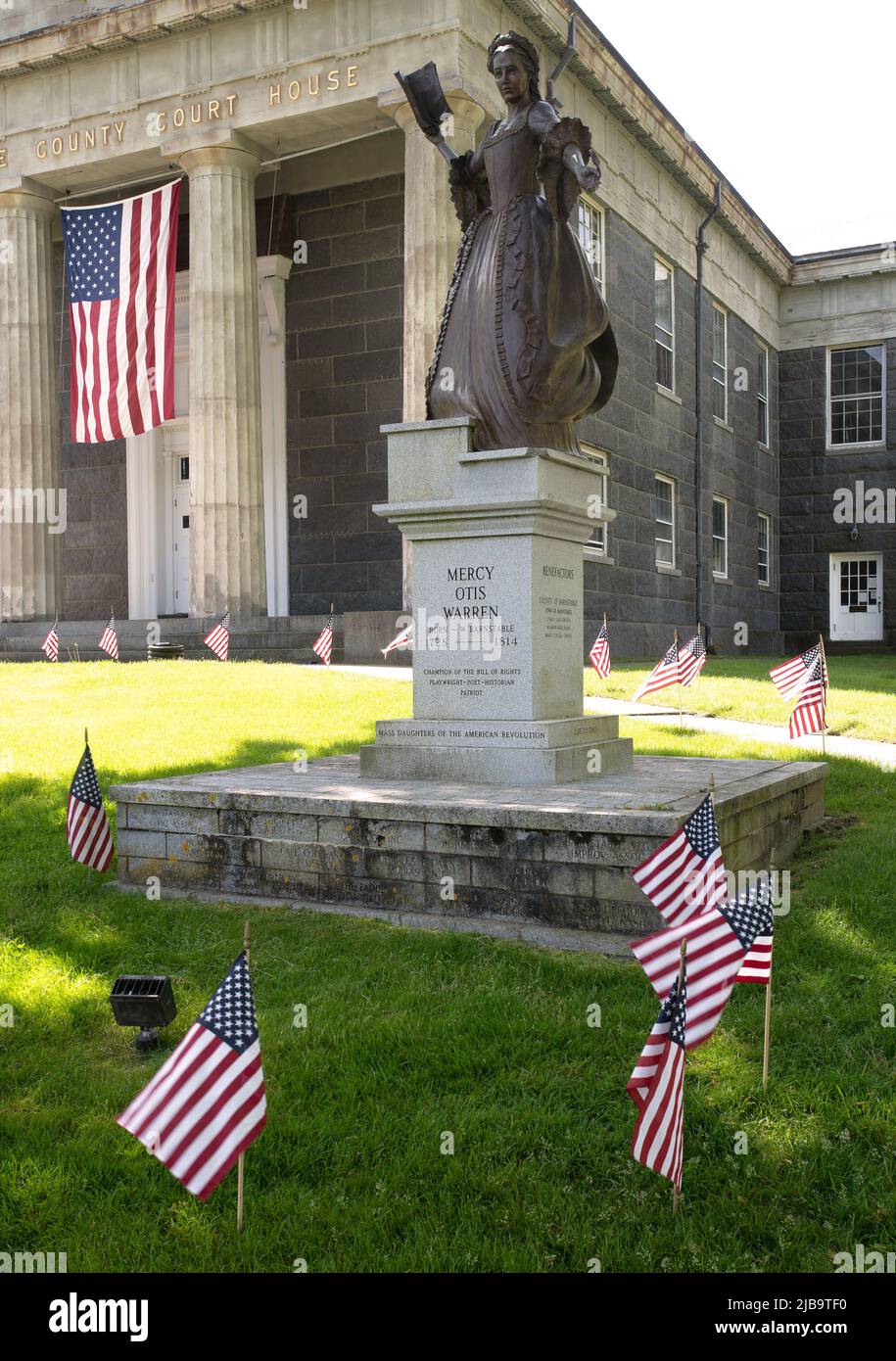 Statue of Mercy Otis Warren (1728 - 1814) and Memorial Day decore on the lawn of the Barnstable County Superior Court in Barnstable, Massachusetts, on Stock Photo
