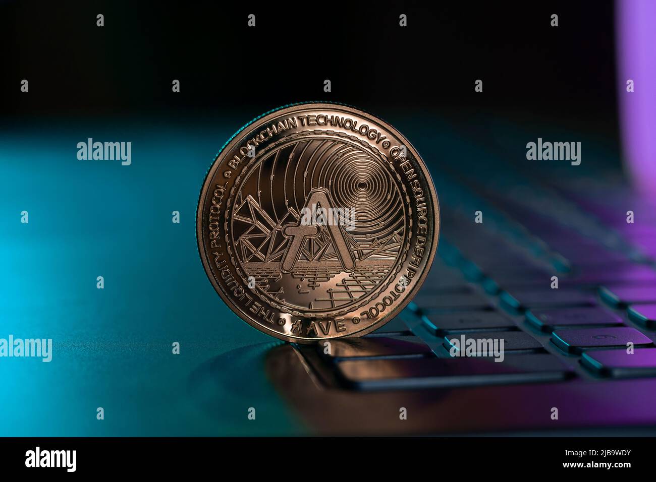 Aave Cryptocurrency Physical Coin Placed Laptop Keyboard and lit with  purple and blue lights Stock Photo - Alamy