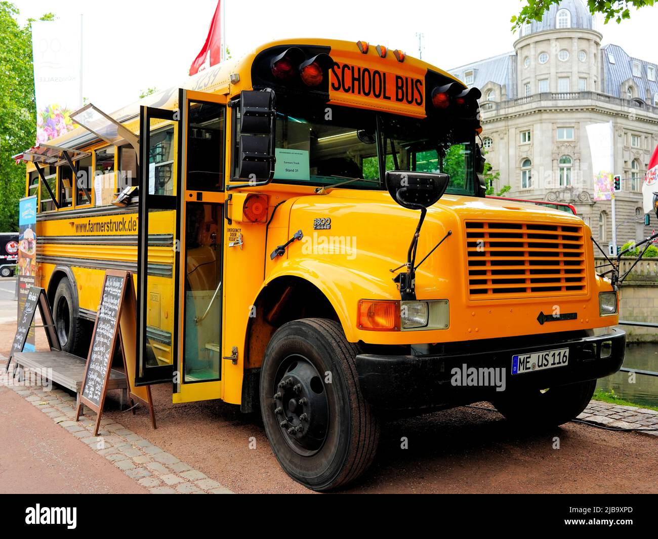 American vintage school bus serving as food truck by Farmer's Truck at Königsallee in Düsseldorf/Germany. Stock Photo