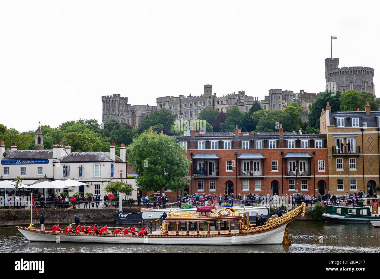 Windsor, UK. 4th June, 2022. Gloriana, the Queen's Row Barge, passes Windsor Castle at the head