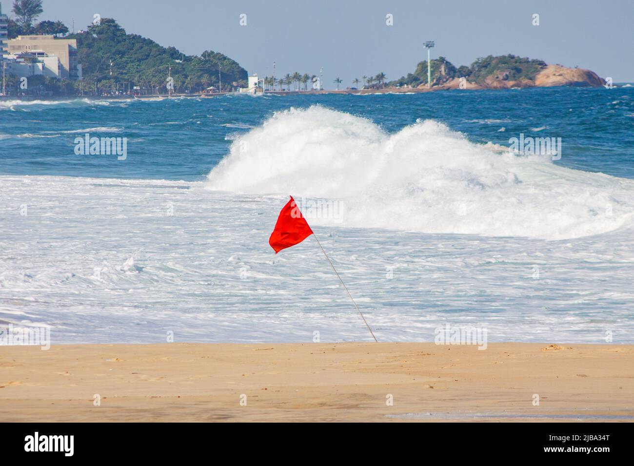 red flag signaling danger when entering the water at leblon beach in Rio de Janeiro Brazil. Stock Photo