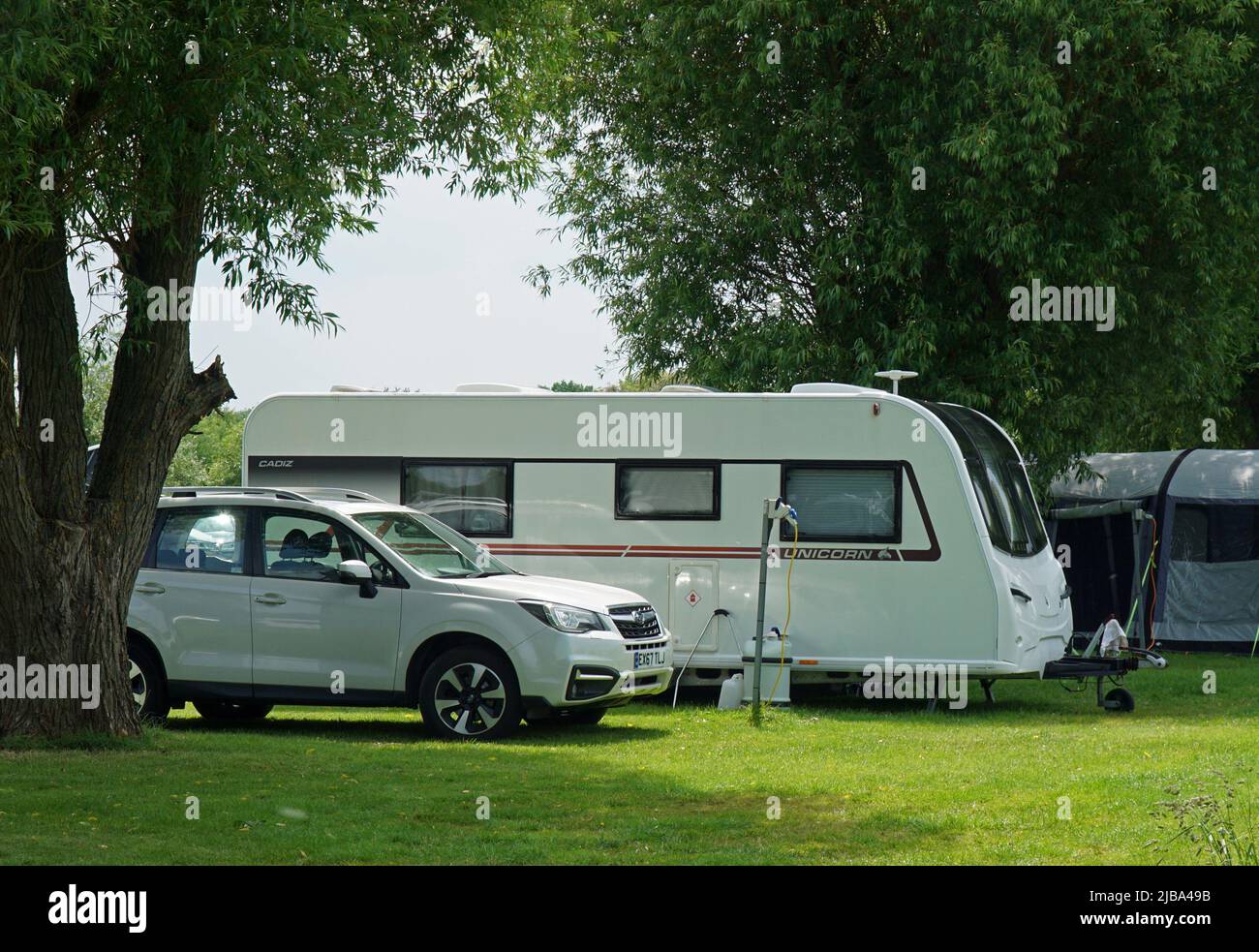 Subaru Forester CRV on Campsite with Unicorn Caravan - Trailer on Campsite. Stock Photo