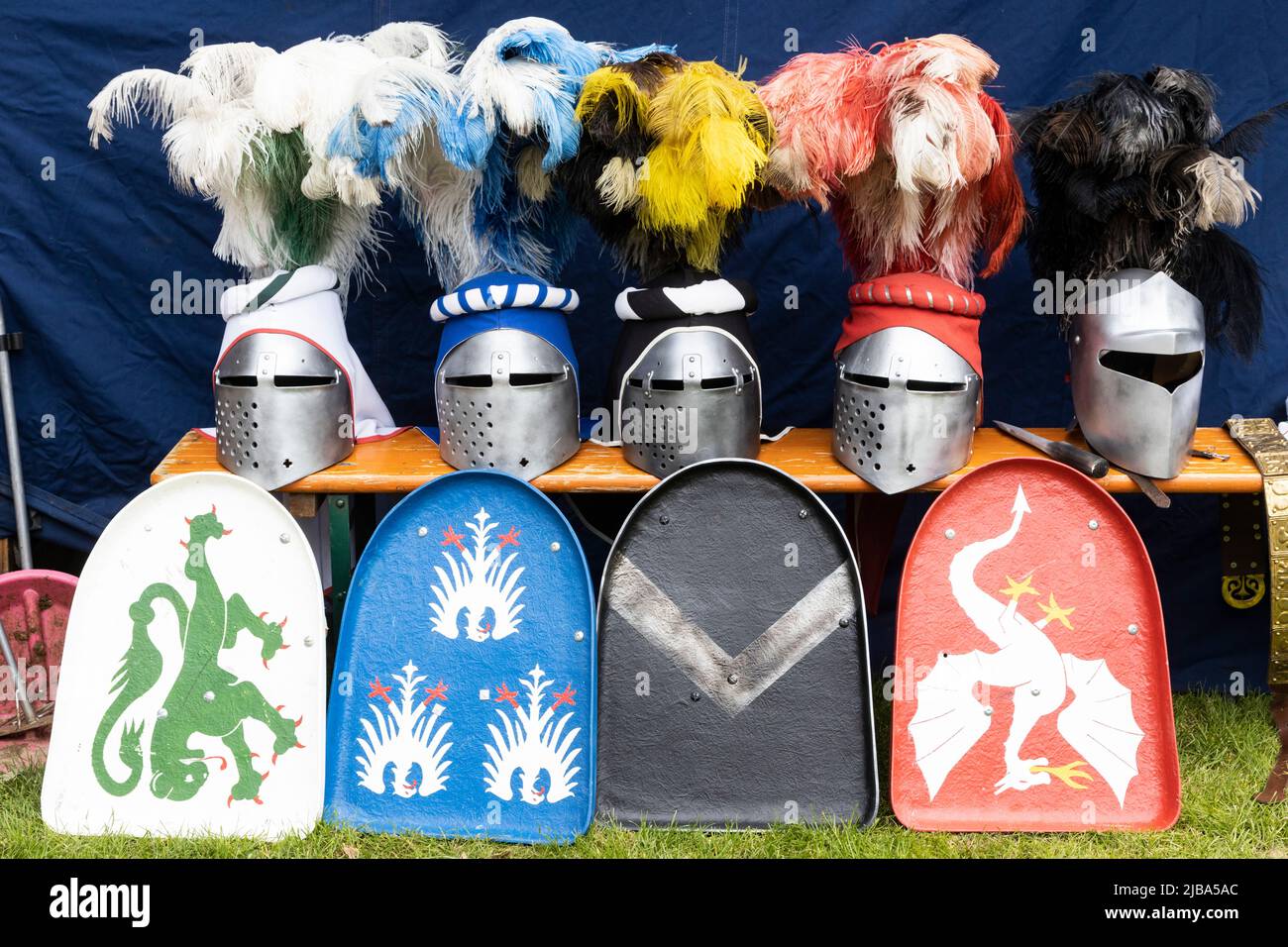 Pfingst-Spektakulum in Muelheim an der Ruhr, Germany. Knights helmets with feathers and shields. Event with a medieval knights tournament with camp and crafts market in Müga-Park near Schloss Broich castle. Stock Photo