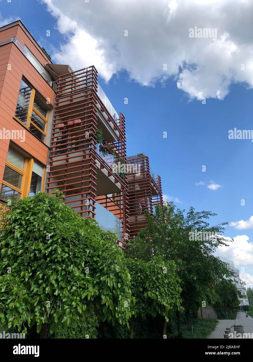 Red high-rise building on a background of blue sky Stock Photo - Alamy