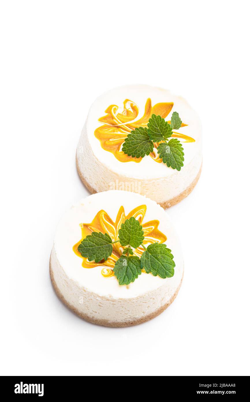 Mini  Cheesecakes decorated with yellow jam isolated on white Stock Photo