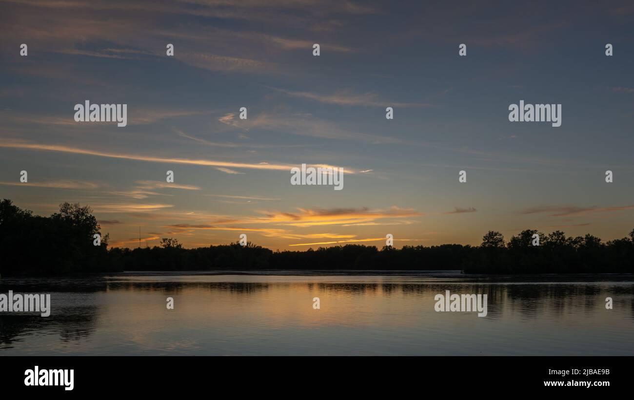 Sunset reflected in the peaceful waters of Ross Lake, Beaverton, Michigan. Stock Photo