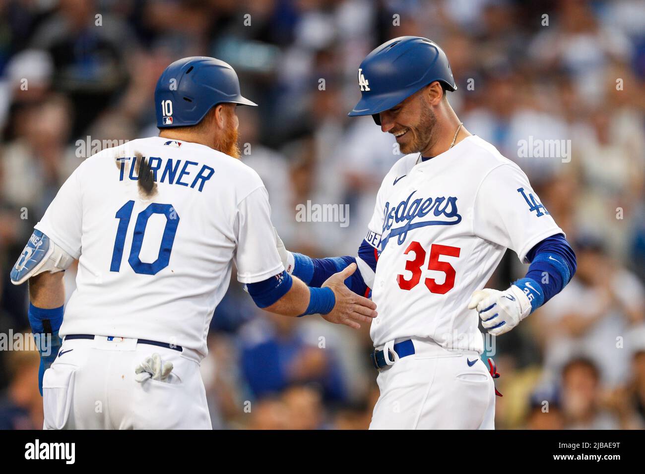 Los Angeles Dodgers centerfielder Cody Bellinger (R) goes down on