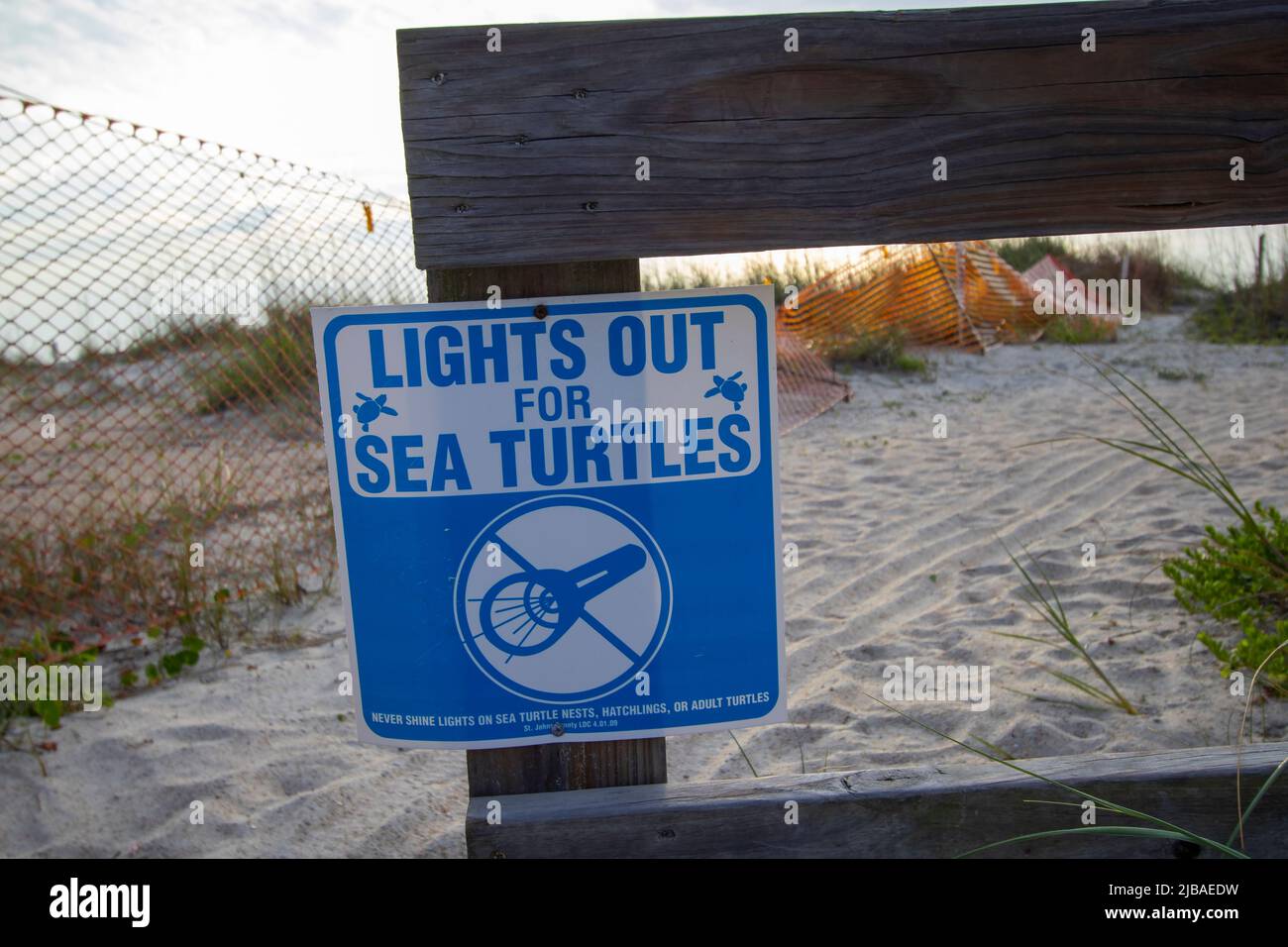 Lights Out for Sea Turtles sign on a Florida beach Stock Photo