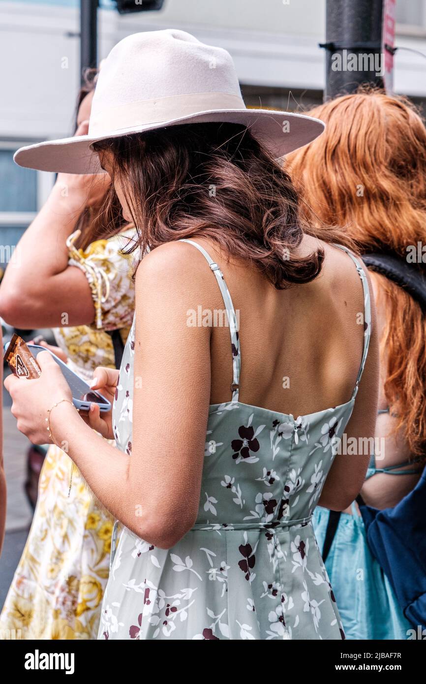 Epsom Surrey, London UK, June 04 2022, Young Woman Wearing A Skimpy Floral Print Summer Dress Stock Photo