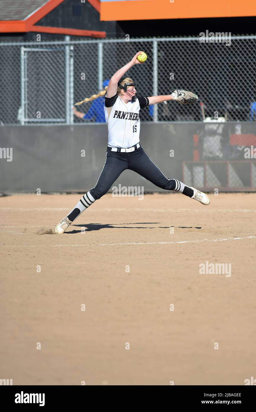 USA. Pitcher in the circle in her windup prior to delivering a pitch to a waiting batter. Stock Photo